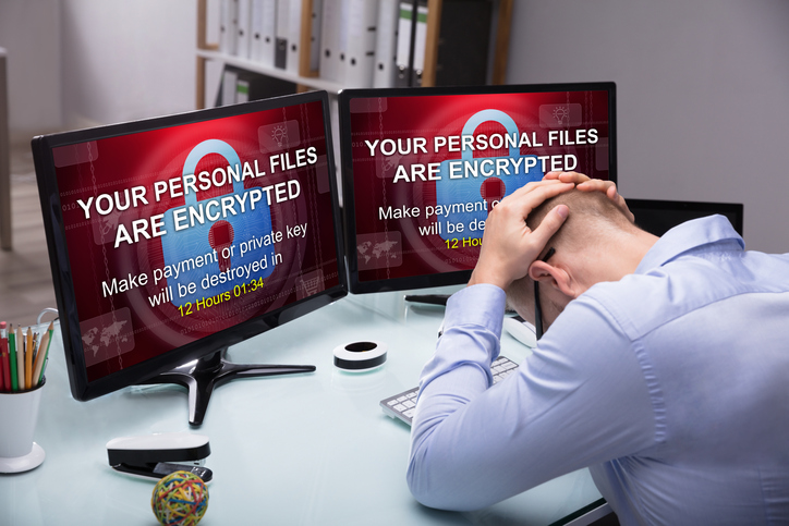 Stressed Businessman Sitting In Office With Computer Screen Showing Personal Files Encrypted Text
